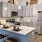 a kitchen with a bar stool and a refrigerator