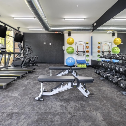 Cutting-edge amenities at your fingertips a gym with exercise equipment