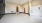 a room with a white floor and a red door